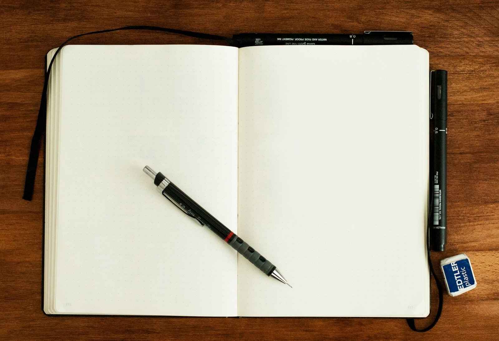 Black and silver pen on a blank notebook