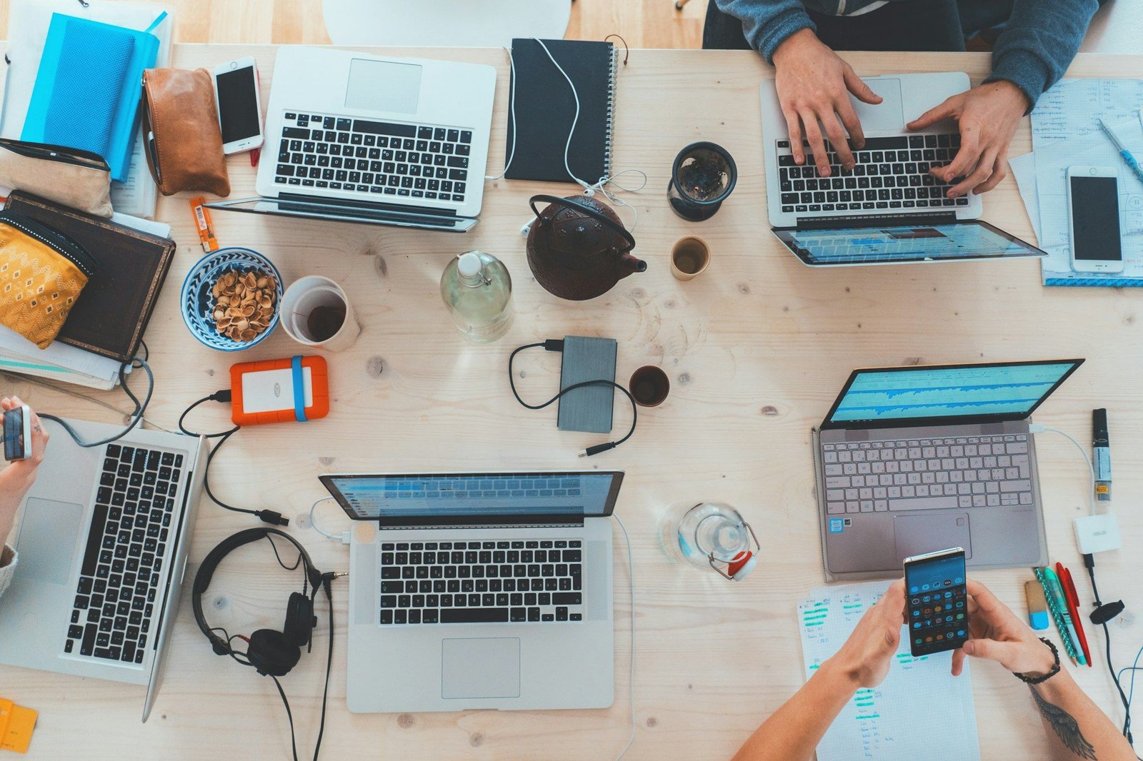 People working together at a table with laptops