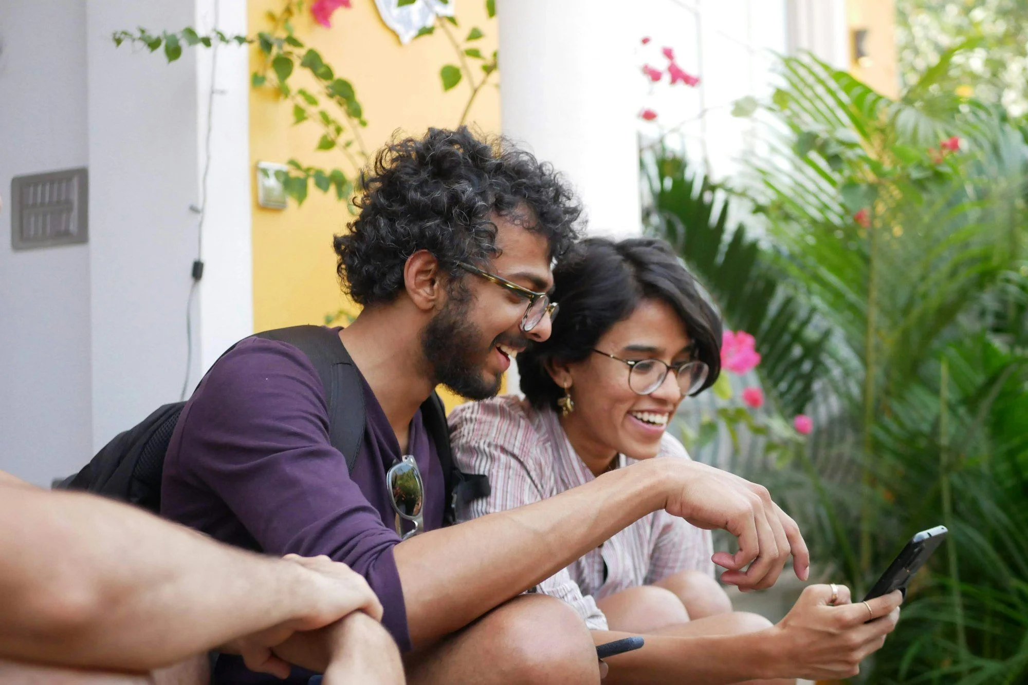 Two young people laughing at a smartphone, the audience TikTok ads reach in the Gulf