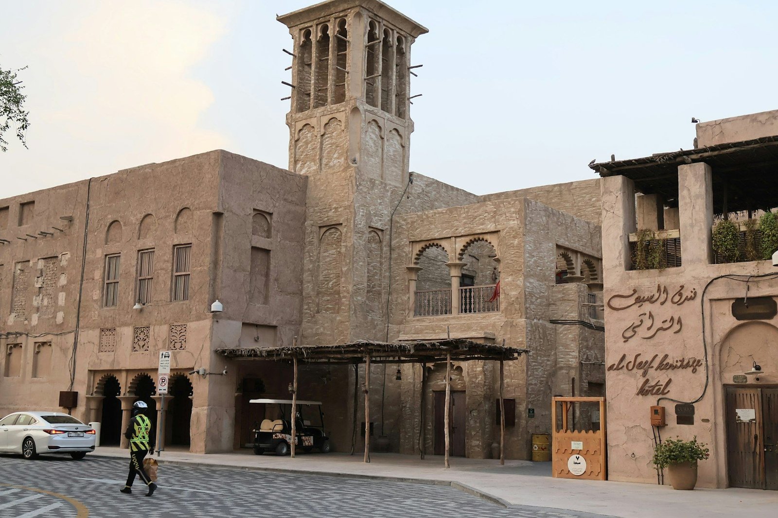 A person walking past the Al Seef Heritage Hotel in Dubai